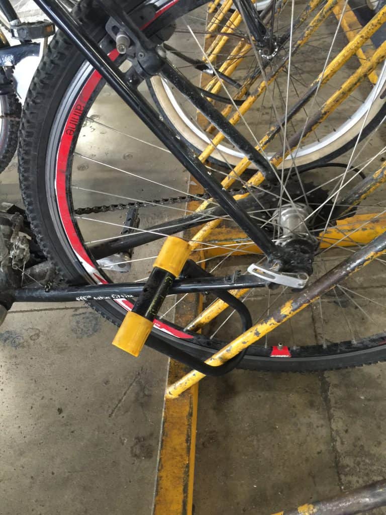 How to lock a rental bike with a U-lock on a bike rack in Playa del Carmen